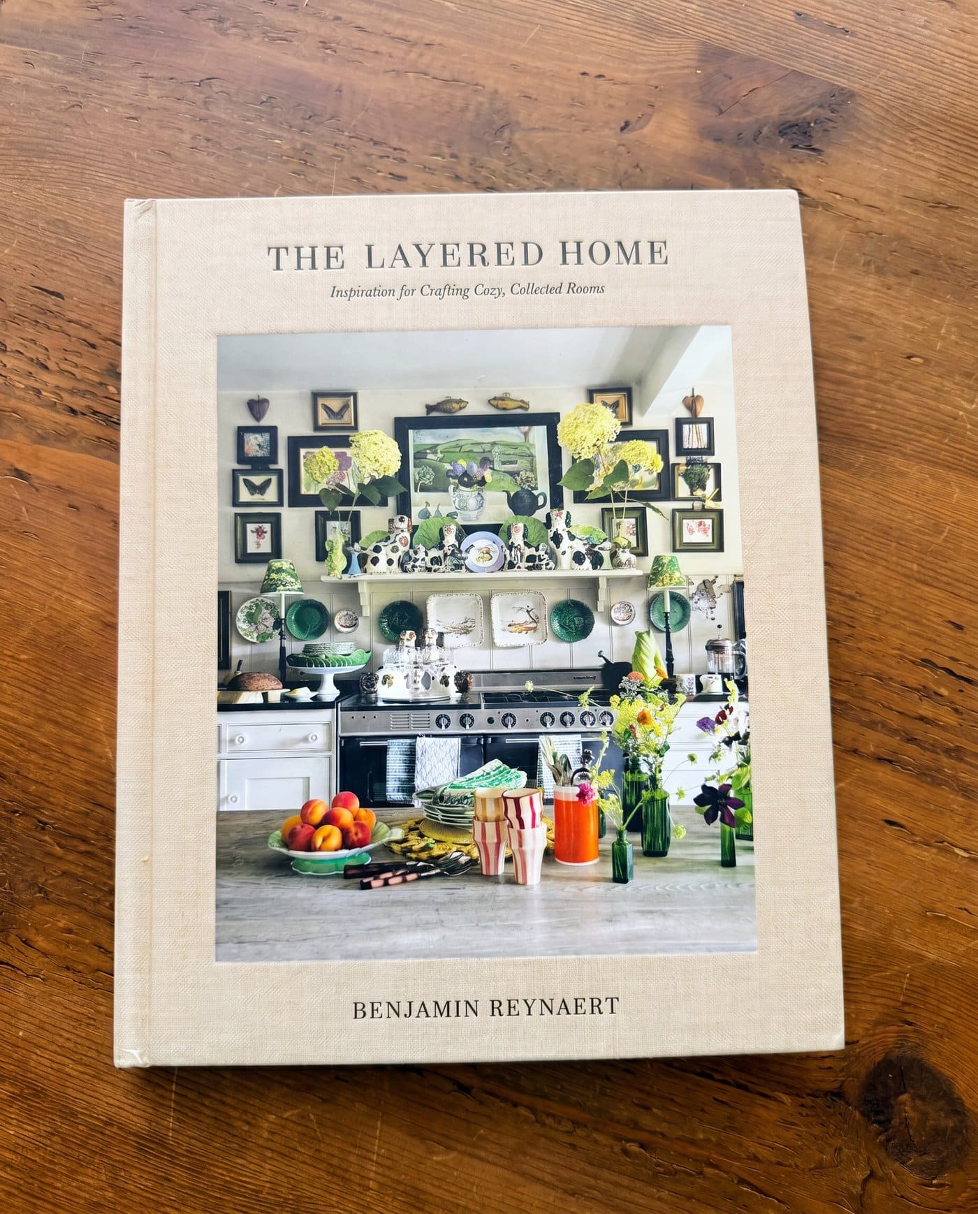 The Layered Home by Benjamin Reynaert book cover styled on a wood table